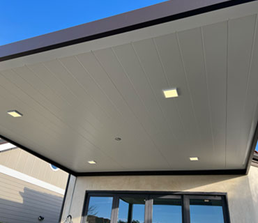 Insulated patio cover with modern design and ceiling fan