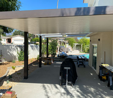 Modern outdoor living space with solid patio cover